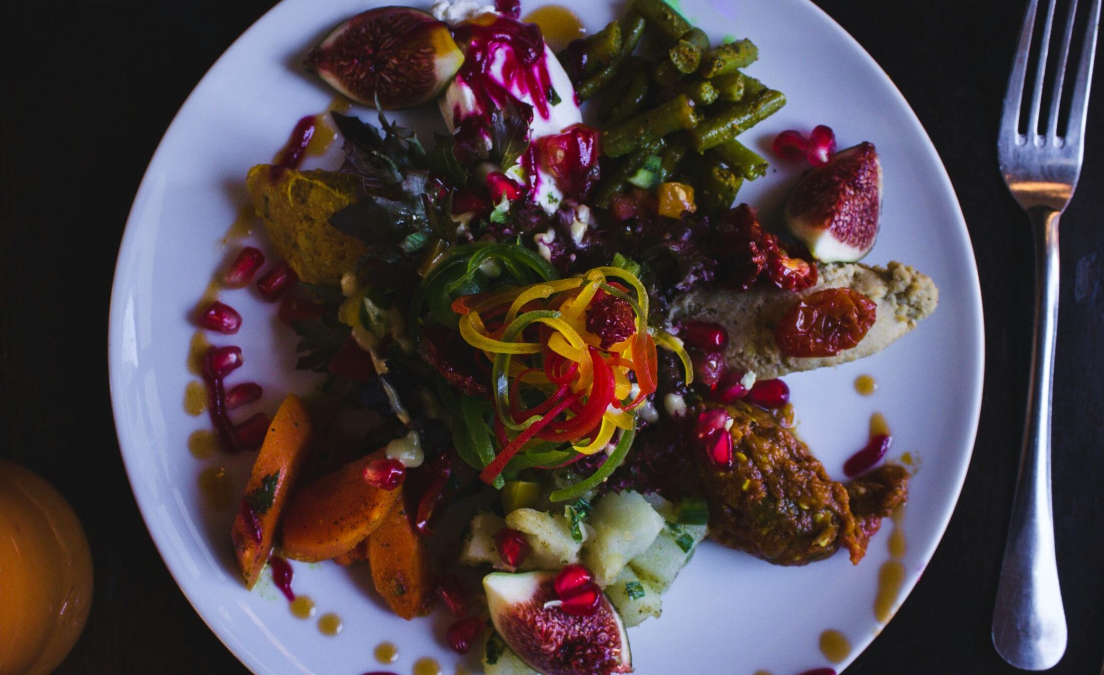 A beautifully arranged table of Middle Eastern dishes including hummus, falafel, and flatbread, representing authentic cuisine in London's best restaurants.