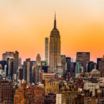 An assortment of iconic New York City foods, including pizza, bagels, and pastrami on rye, showcasing the city's diverse culinary scene.