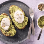 Sourdough toast topped with mashed avocado and spicy kimchi, a Korean-American fusion breakfast favorite.