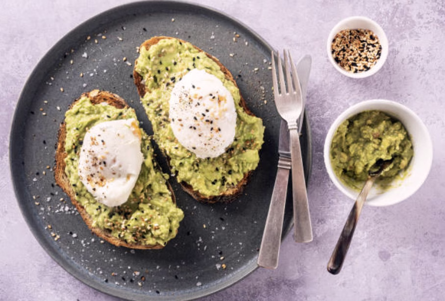 Sourdough toast topped with mashed avocado and spicy kimchi, a Korean-American fusion breakfast favorite.
