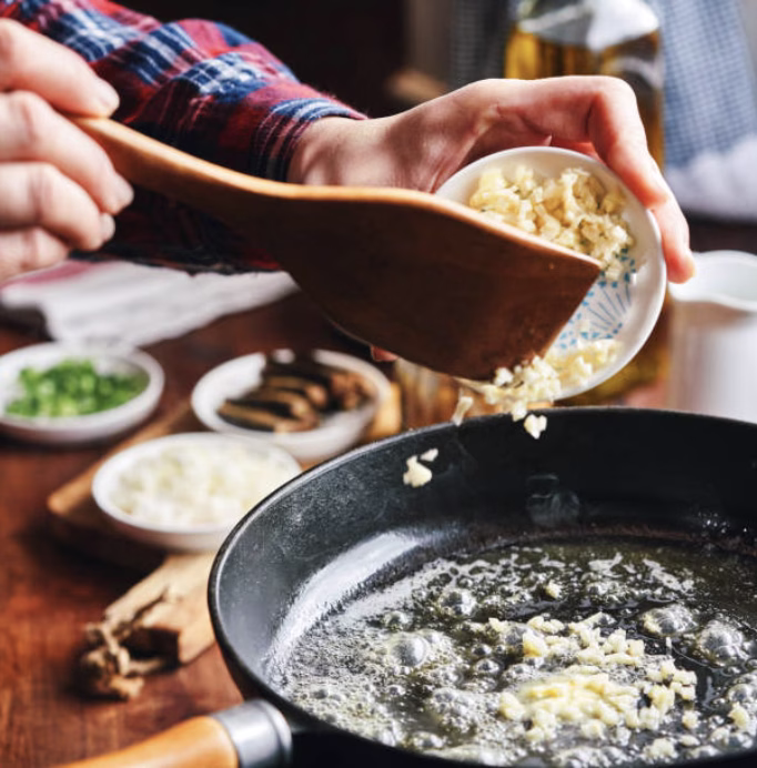 Sautéing garlic in a pan for the rose tteokbokki sauce base.