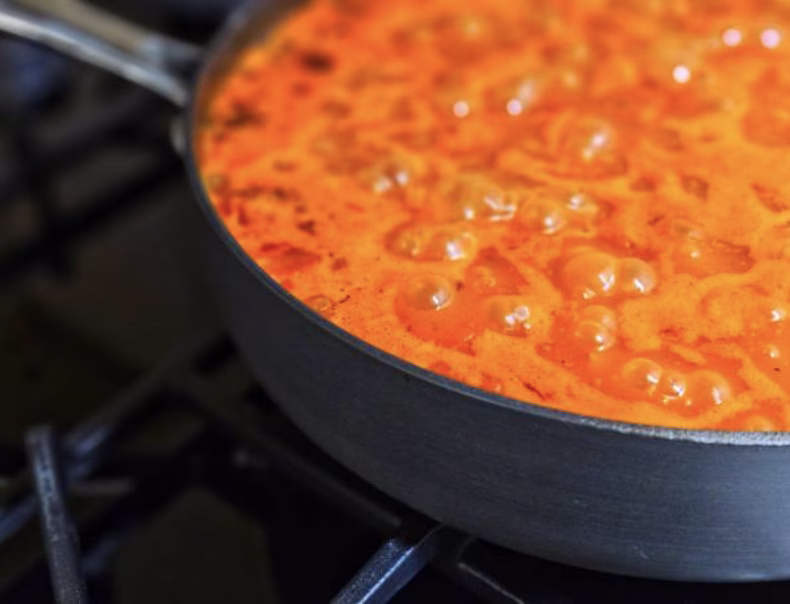 Addingheavy cream into the spicy sauce to make it creamy for Rose Tteokbokki.