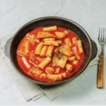 Spicy Rose Tteokbokki with red chili flakes.