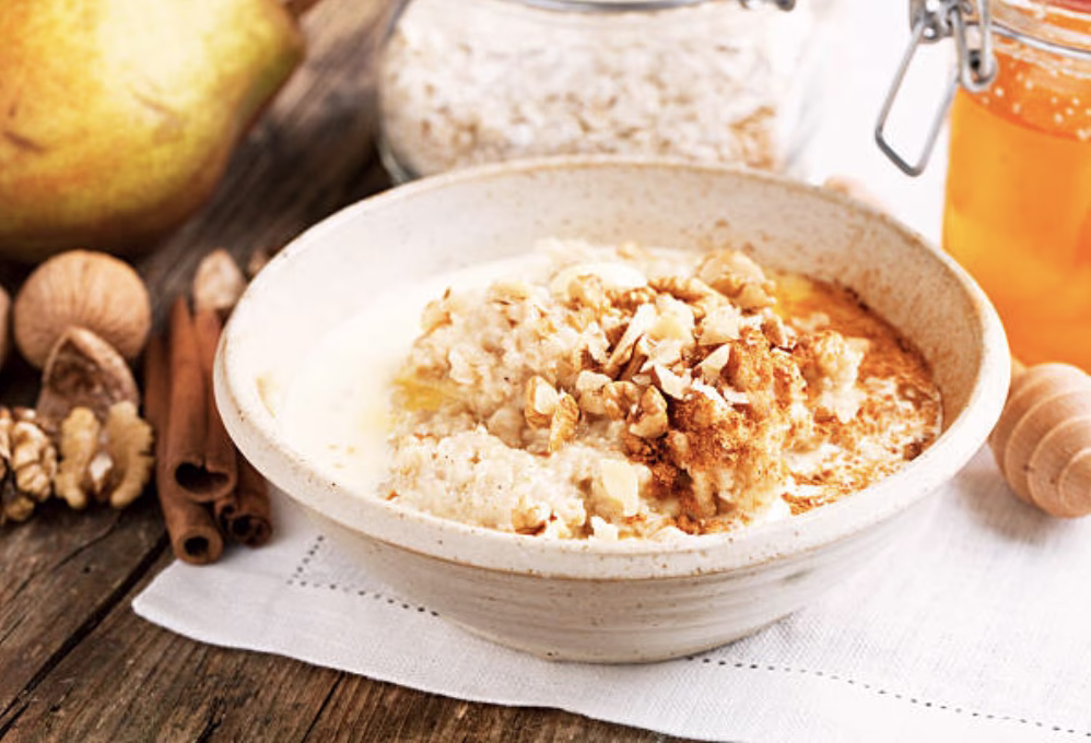 Bowl of oatmeal infused with gochujang, topped with nuts and seeds—a gochujang breakfast idea.