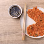 Crispy kimchi pancake served with dipping sauce, a quick kimchi recipe for a Korean-American fusion breakfast.