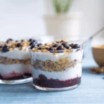 Layered yogurt parfait with fruit and granola, representing a Korean-American fusion breakfast.