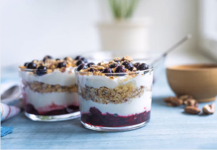 Layered yogurt parfait with fruit and granola, representing a Korean-American fusion breakfast.