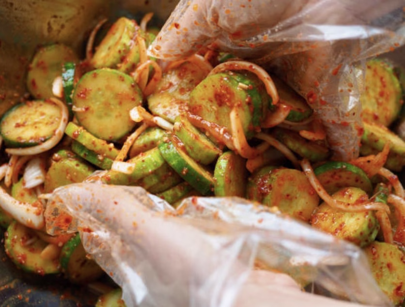 Step 2 of quick cucumber kimchi recipe – mixing marinade with soy sauce, vinegar, garlic, and gochugaru.
