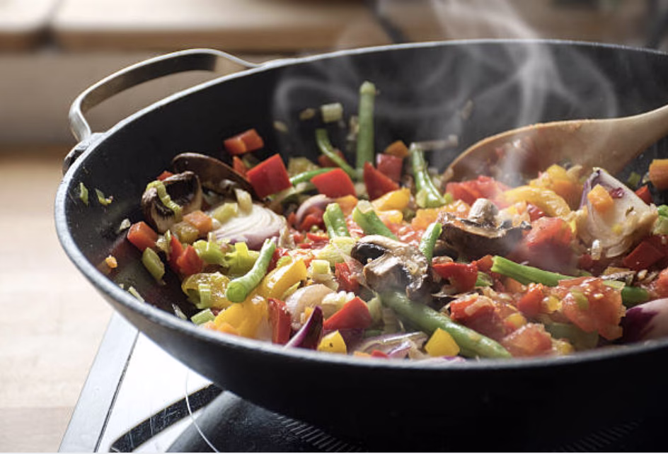 Stir-frying frozen stir-fry vegetables in a skillet for japchae