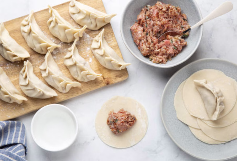 Mandu filling made with ground turkey, sauerkraut, and coleslaw mix in a mixing bowl