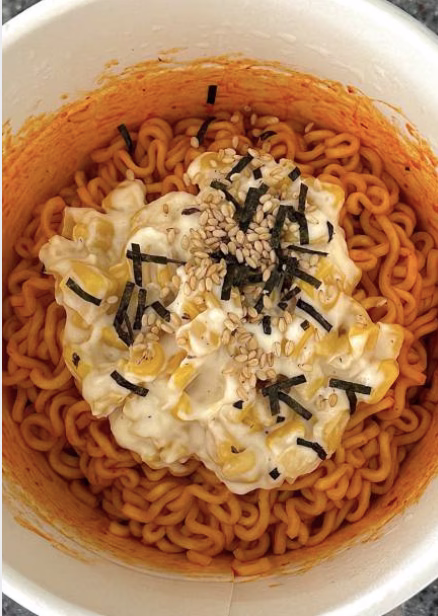 Ramen topped with Colby Jack cheese ready to broil for buldak chicken recipe